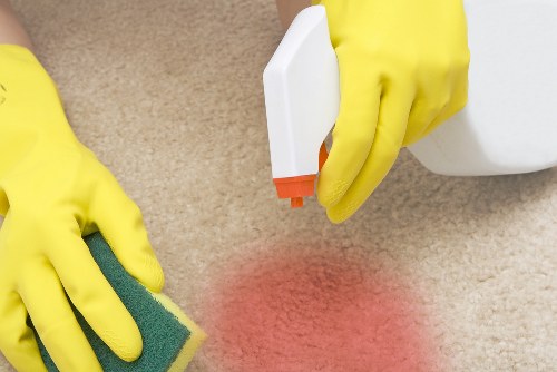 Carpet cleaner preparing a room for a scheduled service