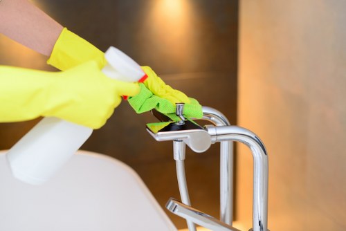 Cleaner wearing PPE while operating cleaning equipment