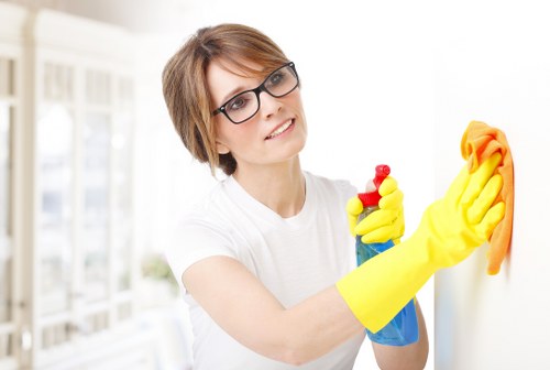 Cleaner using safe carpet cleaning practices with protective equipment