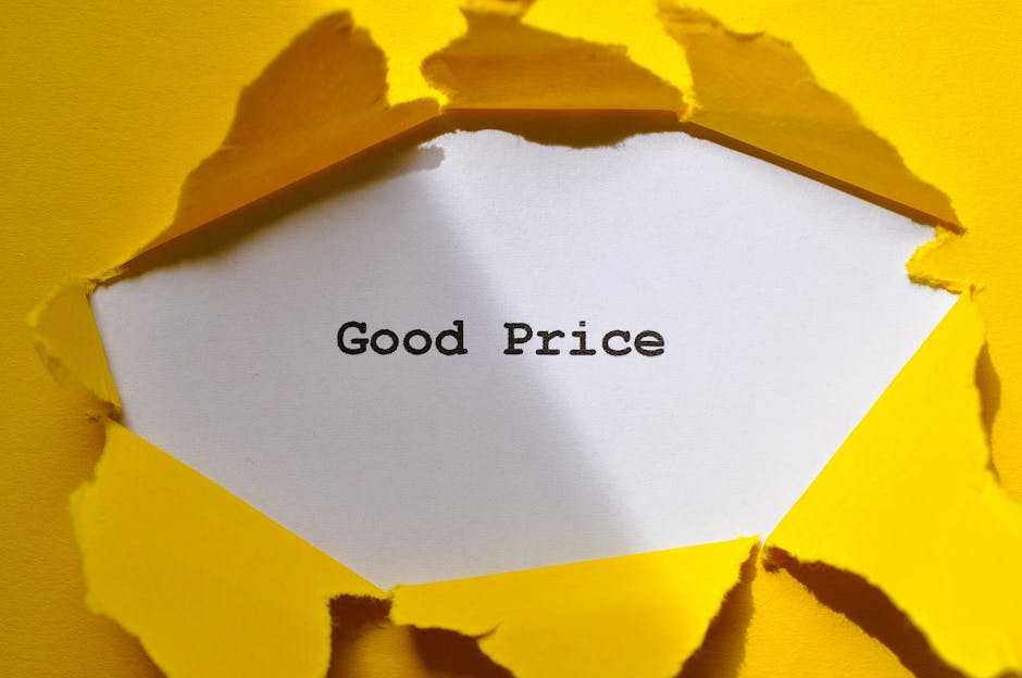 A close-up image showing a torn yellow paper with jagged edges, revealing a white sheet underneath with the words 'Good Price' printed in black text. The torn paper creates a layered effect, emphasizi